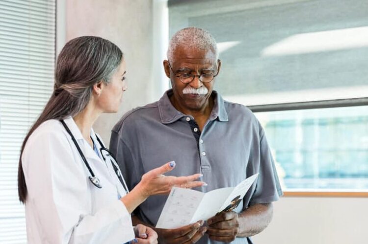 Female doctor consulting with African American male patient