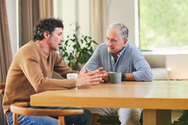 adult son talking with his father